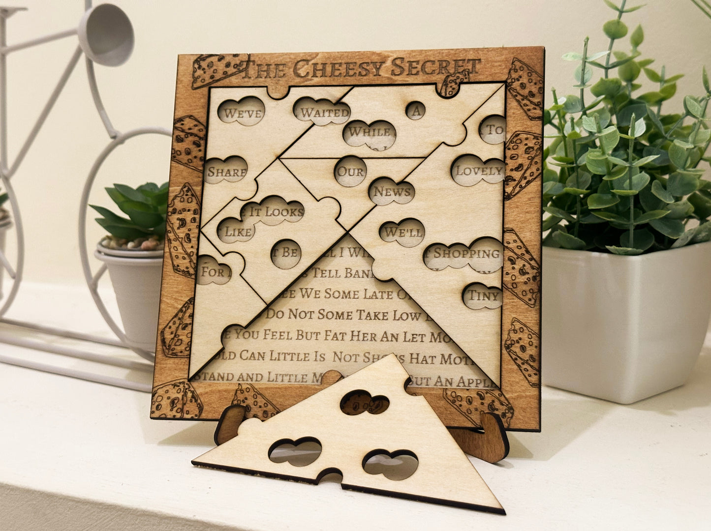 Pregnancy Announcement Wooden puzzle with baby reveal riddle surrounded by plants family surprise
