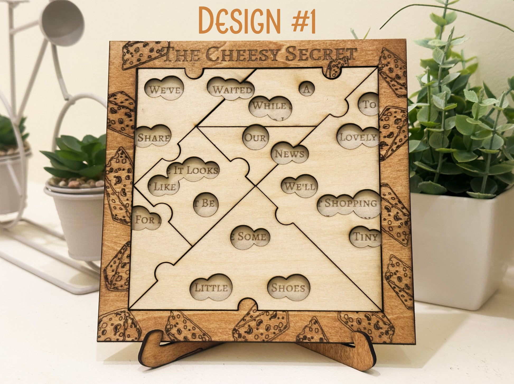 Pregnancy Announcement Wooden puzzle with baby reveal riddle surrounded by plants.
