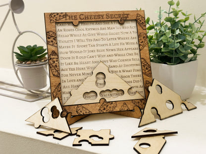 Wooden cheese-shaped puzzle with a decorative frame on a table with plants.